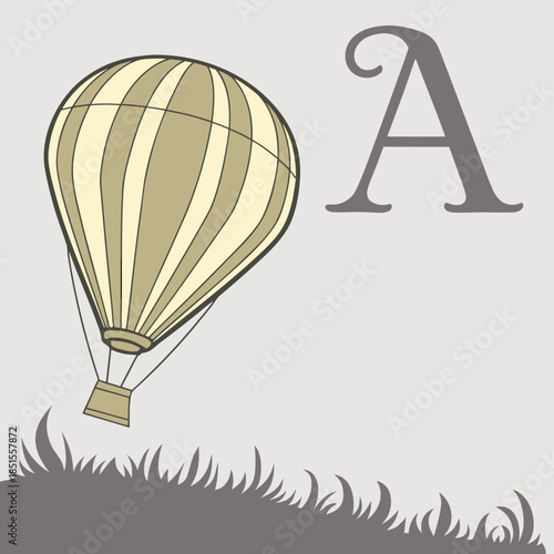 Hot air balloon flying over grassy hill with large letter A.