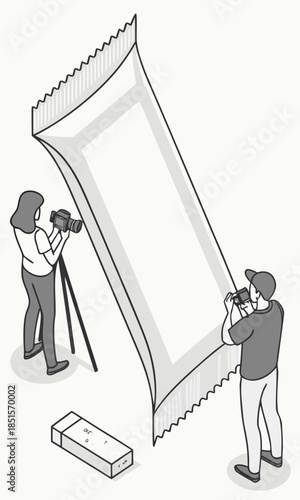 Two people photographing a large blank snack bar wrapper in a studio setting.