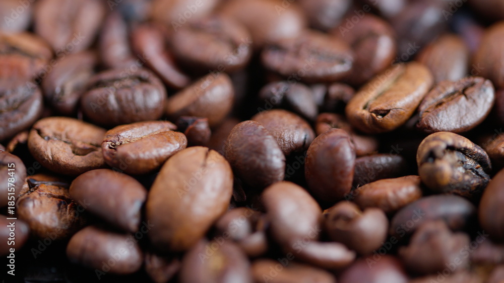 Fototapeta premium Coffee bean closeup, Detailed shot of aromatic brown coffee beans with subtle oil, Highquality depiction of aromatic roasted coffee beans with appealing gloss and warm hues