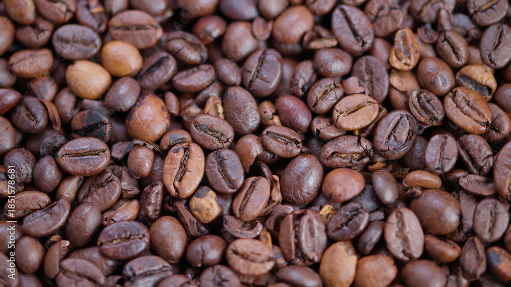 Fototapeta premium Highdefinition image focusing on shiny roasted coffee beans with detailed surface, Macro photograph capturing textured roasted coffee beans with oily sheen and warm lighting