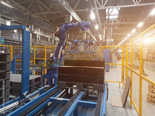A robotic arm in a lead-acid battery production plant. flare, beam