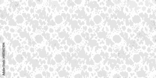 Abstract grayscale texture with irregular scattered dark shapes on a light background