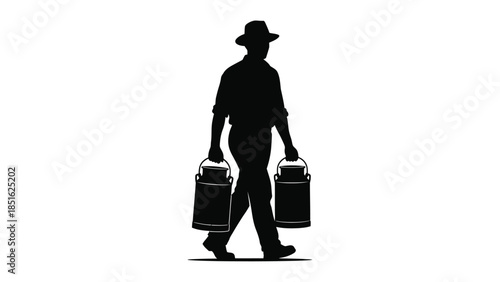 Silhouette of a farmer wearing a hat walking while carrying two traditional milk cans by their handles