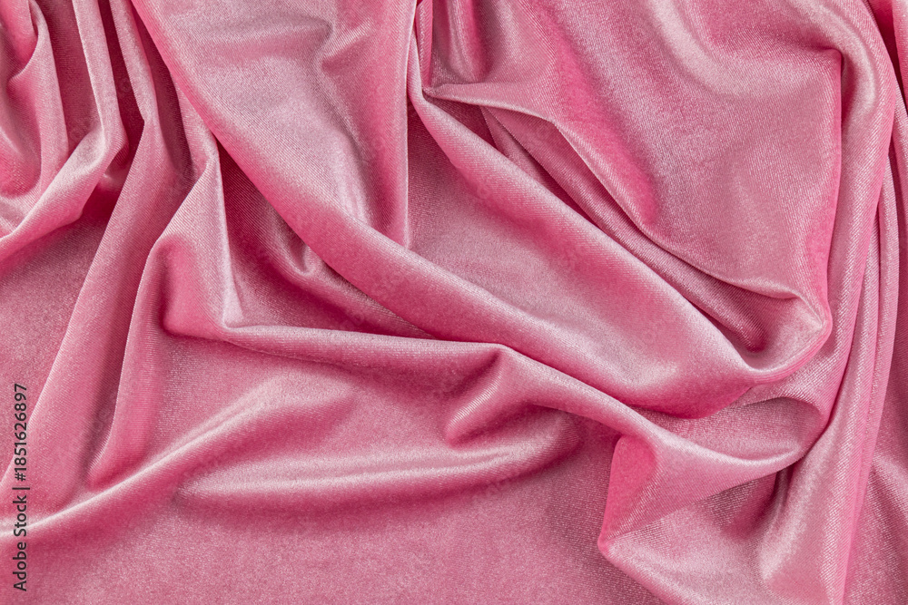 Obraz premium Chic velvet background of pink velvet fabric with smooth beautiful pleats. The concept of a festive background. layout for design. top view