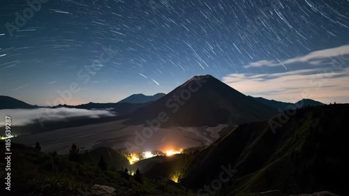 Time Lapse of Stars Rotating Above Dormant Volcano With Moonlit Clouds and Cinematic Wide Angle Night Sky