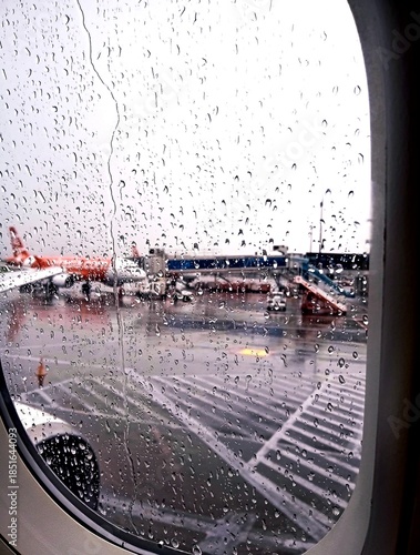 close up of the wet airplane window glass from the rain, serene and calming