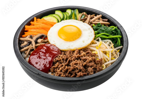 Vibrant Korean bibimbap bowl displays a medley of rice, vegetables, protein, and egg, presented in a dark bowl against a black backdrop.