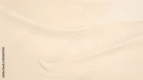 A smooth and creamy beige texture with subtle waves creates a luxurious and elegant backdrop for various design applications