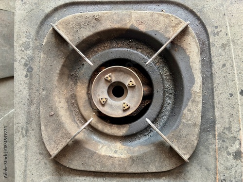 Top view of dirty and dusty gas stove burner in household kitchen