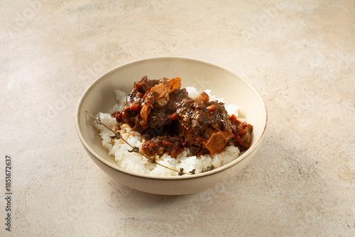 Quadro su tela A view of a plate of braised oxtail and rice.