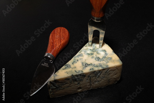 Canvastavla Blue cheese slice on a black background.