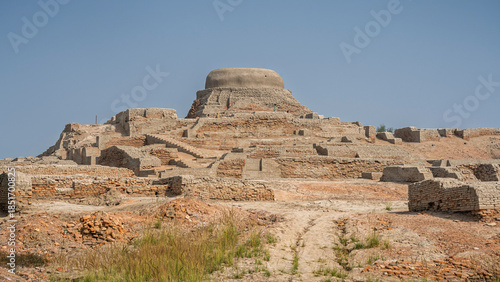 Landscape view of citadel mound with buddhist stupa in archaeological ruins of UNESCO World Heritage Mohenjo-Daro, Larkana, Sindh, Pakistan
