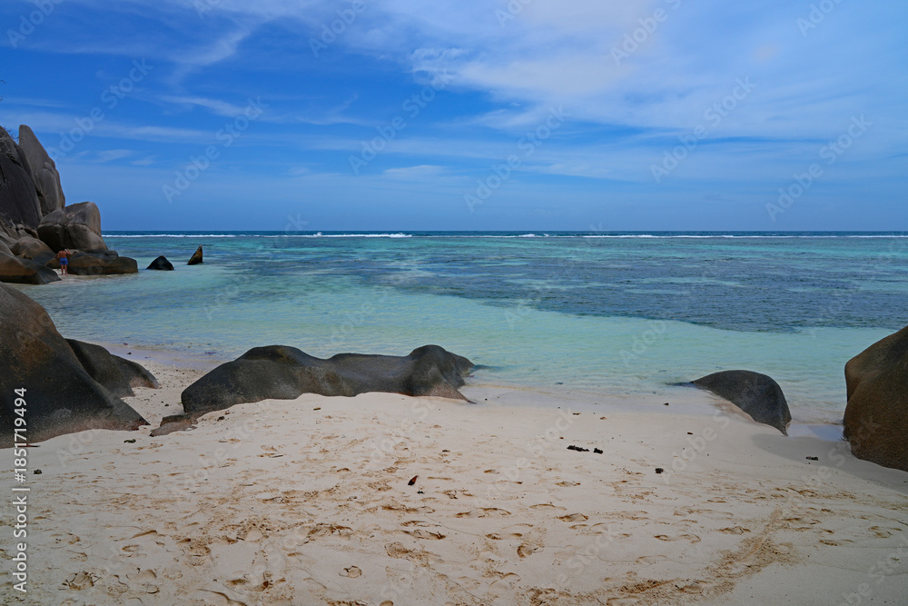 Fototapeta premium Day view of the Anse Source d Argent beach with its granite boulders on La Digue island in the Seychelles, one of the most beautiful beaches in the world