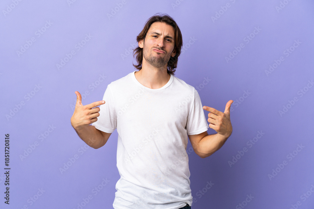 Fototapeta premium Young handsome man isolated on purple background proud and self-satisfied