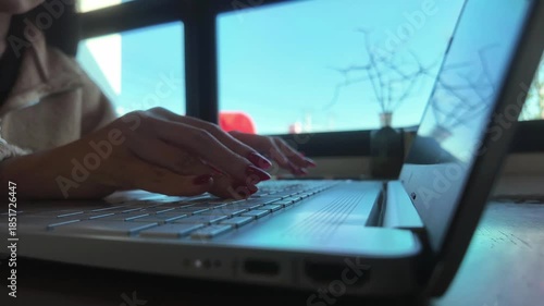 Time lapse of side view close-up woman typing on keyboard on laptop at table in cafe on holiday. Concept of working outdoors, comfortable workspace or freelance career, footage horizontal