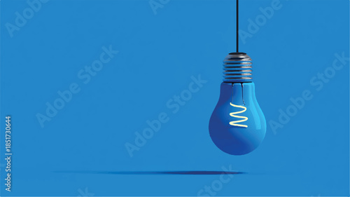 blue light bulb with glowing filament hanging on cord