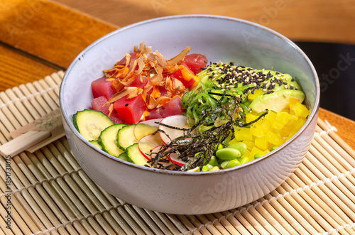 Healthy Poke bowl with tuna on wooden background.