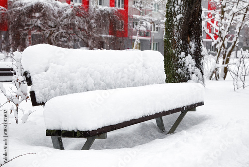 Wallpaper Mural Snow covered park bench after heavy snowfall creating quiet winter urban scene Torontodigital.ca