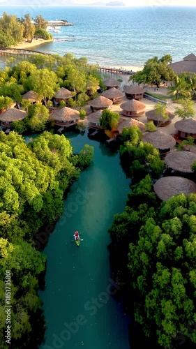 Discover the stunning landscapes of Koh Phayam in Thailand, featuring lush mangroves, charming huts, and calm waters. Experience the peacefulness of nature in this tropical paradise.