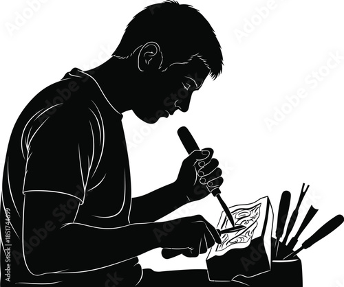 Silhouette of a craftsman carving detailed patterns by hand