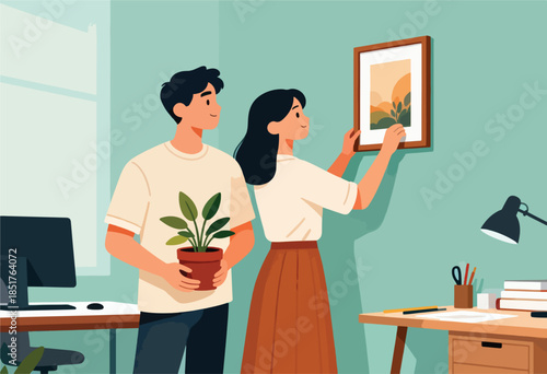 Couple decorates a room, hanging a painting while holding a potted plant