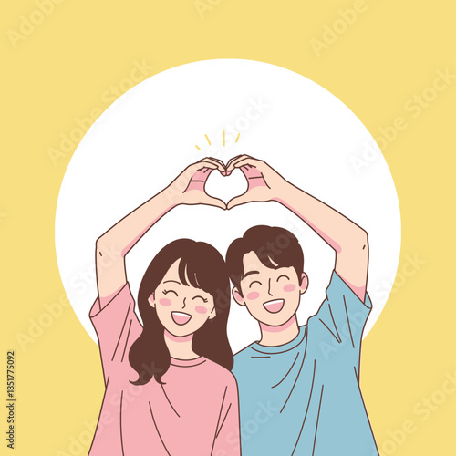 Young couple forming a heart shape with their hands together in front of a bright background