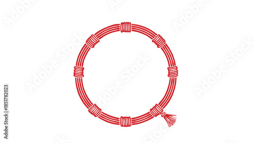 A red woven bracelet with a tassel hangs in a circular shape.