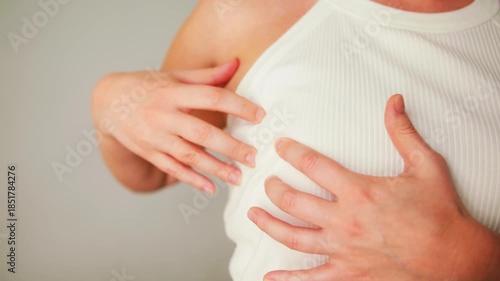 Wallpaper Mural Woman is performing a self-examination, checking breasts by palpation to feel for any lumps, thickenings, or changes in breast and armpit tissue. . High quality 4k footage Torontodigital.ca