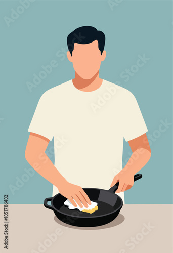 Person cleaning a cast iron skillet with a cloth on a counter