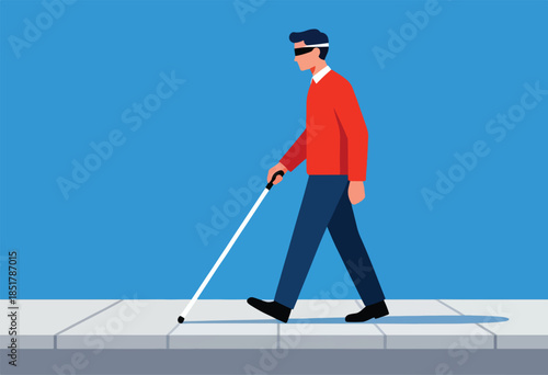 Person wearing blindfold walks on sidewalk with a white cane