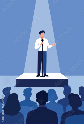 Man on stage with microphone addressing audience in spotlight