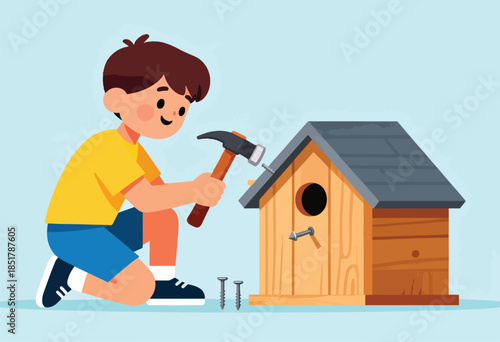 Young boy building a wooden birdhouse with a hammer and nails