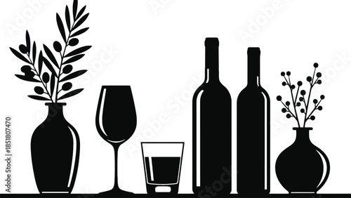 Still life arrangement of wine bottles, glasses, and vases with foliage.