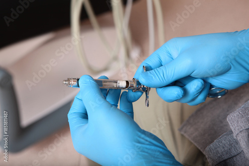 Anesthesia in dentistry. The syringe is in the doctor's hands. Dental syringe for anesthesia. The concept of modern medicine. Close-up.