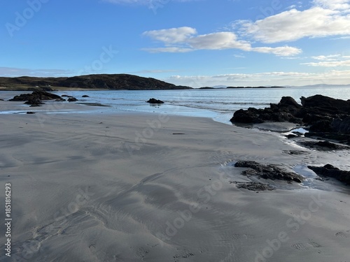 Beautiful wild beach Isle of Mull Scotland Uisken the beautiful rocky and sandy shore sunrise with water pools reflect sun light  vast ocean on horizon with wildlife  and blue sky in Winter no people