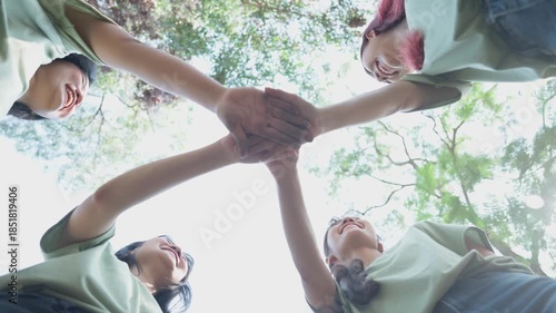 Circle of Unity: A circle of hands linked together, a symbol of teamwork and togetherness. View from below and show the beauty of nature.