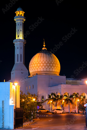Sur, Oman - November 22,2025: Close-up Night View of the Distinctive Illuminated Dome and Minaret of Bahwan Mosque in Sur, Oman