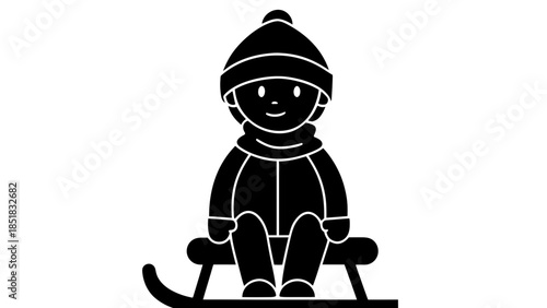 Happy child sitting on a sled in winter gear
