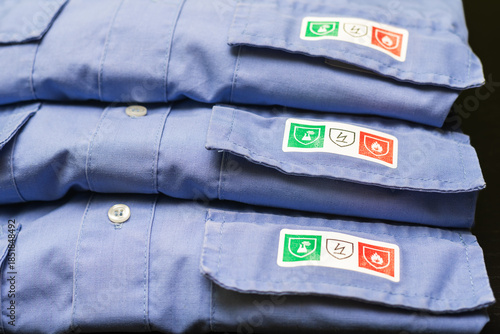 Obraz na płótnie Protective work shirts with fire resistant, chemical and antistatic safety picto