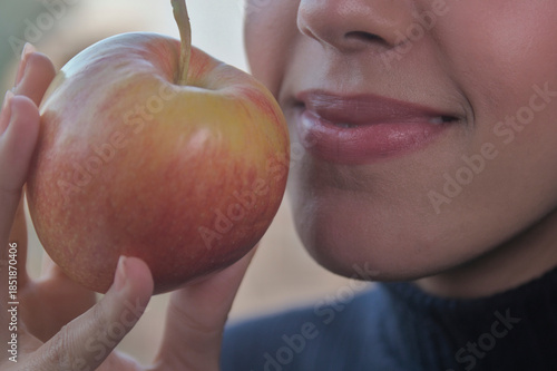 Healthy lifestyle concept. Woman eating a red apple