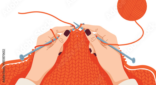 Close-up of hands knitting with bright orange yarn and needles crafting a large piece of cozy knitted fabric.