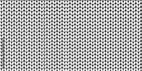 Close up of a textured tightly woven black and white knit fabric