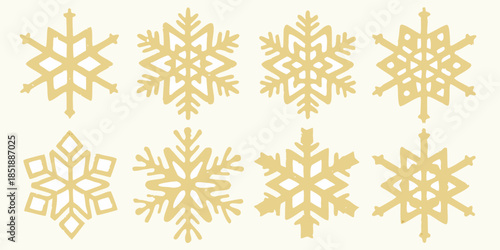 A collection of delicate golden snowflakes arranged on a pale background