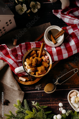 Vertical cozy winter flat lay with cookies, cocoa and festive decor. Warm holiday mood and rustic home comfort concept.