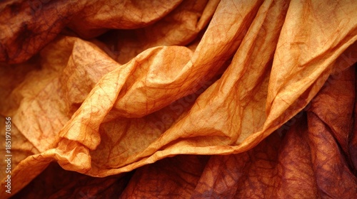 Close up view of richly textured, rumpled fabric displaying warm autumnal colors