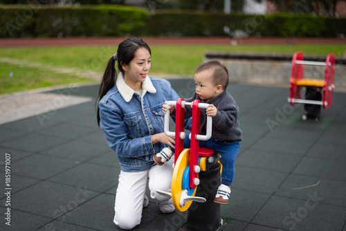 Wallpaper Mural Mother take baby play rocking chair at park Torontodigital.ca