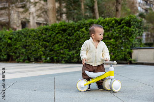 Wallpaper Mural Toddler Practicing Riding Bicycle In Garden Torontodigital.ca