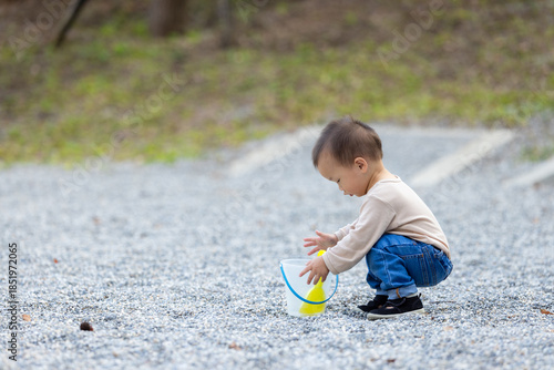 Wallpaper Mural Young child enjoying pebble game at park Torontodigital.ca