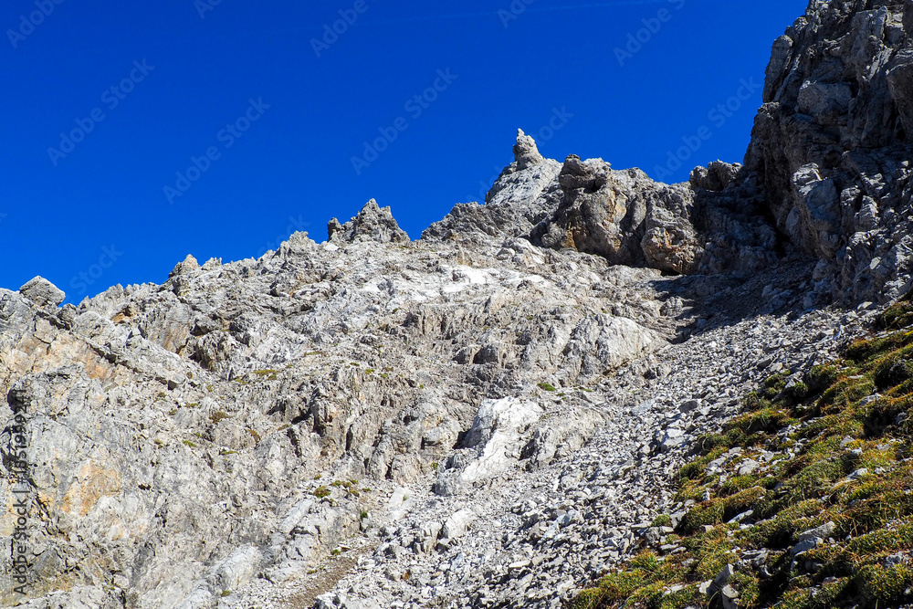 Fototapeta premium Wild Lechtal Alps with rugged peaks and a tranquil alpine mountain lake.