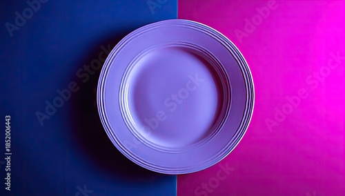 Single purple plate rests on a divided background of dark blue and bright magenta.